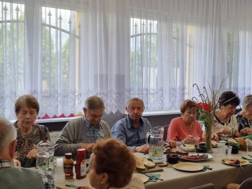 Seniorzy przy poczęstunku