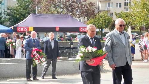 Zbliżenie na dwóch panów, którzy idą z kwiatami